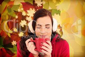 Composite image of woman in winter clothes enjoying a hot drink
