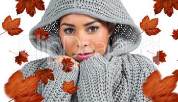 Composite image of pretty girl in winter jumper looking at camer