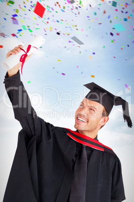 Composite image of happy attractive boy celebrating his graduati