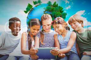 Composite image of children using digital tablet at park