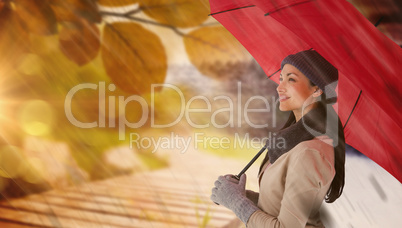 Composite image of smiling brunette holding red umbrella