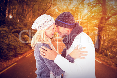 Composite image of smiling cute couple romancing over white back