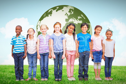 Composite image of cute pupils smiling at camera in classroom