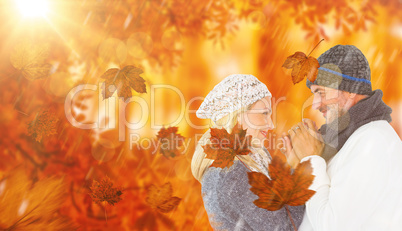 Composite image of cute smiling couple holding hands