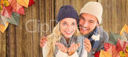 Composite image of attractive couple in winter fashion smiling a