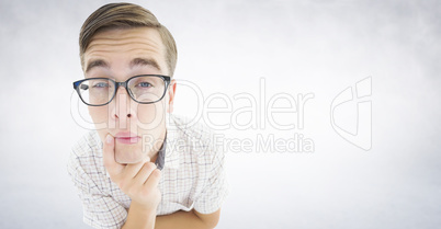 Composite image of geeky hipster thinking with hand on chin