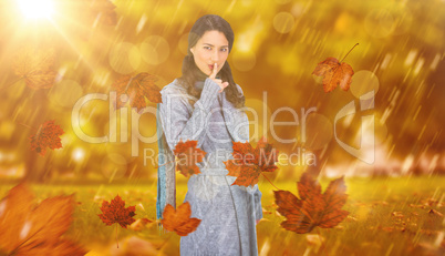 Composite image of young model with winter clothes keeping secre