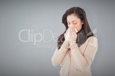 Composite image of sick brunette blowing her nose