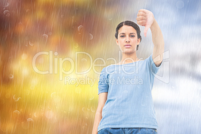 Composite image of pretty brunette giving thumbs down