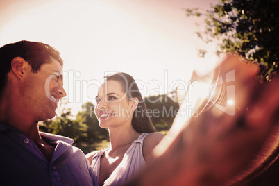 Composite image of loving and happy couple dancing at park
