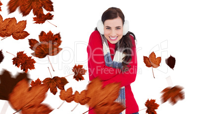 Composite image of happy brunette in winter clothes smiling at c