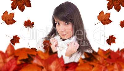 Composite image of brunette in winter clothes smiling at camera