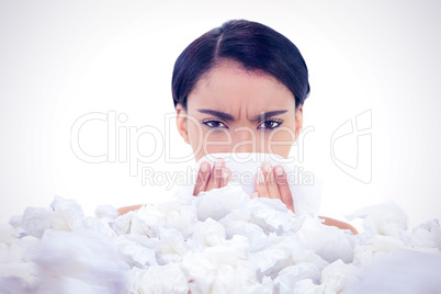 Composite image of sick gorgeous model blowing her nose