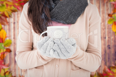 Composite image of woman holding polka dotted mug
