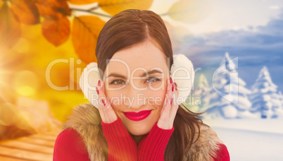 Composite image of brunette in winter clothes smiling at camera