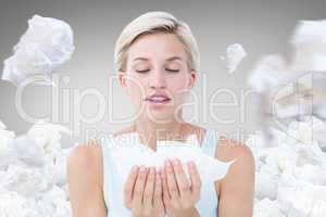 Composite image of sick woman holding tissues