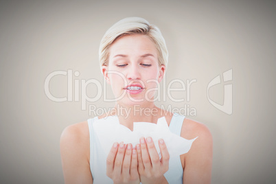 Composite image of sick woman holding tissues