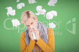 Composite image of close up of woman blowing her nose