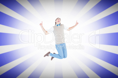 Composite image of geeky hipster jumping and smiling