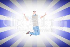 Composite image of geeky hipster jumping and smiling