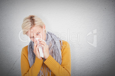 Composite image of close up of woman blowing her nose