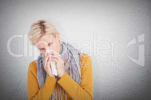 Composite image of close up of woman blowing her nose