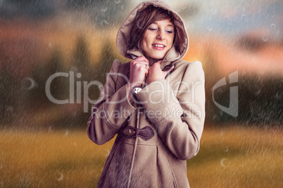 Composite image of smiling woman in winter coat
