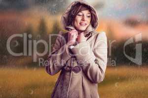 Composite image of smiling woman in winter coat