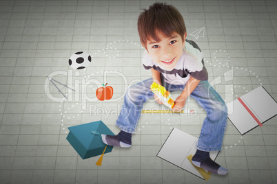 Composite image of cute boy sitting with building blocks