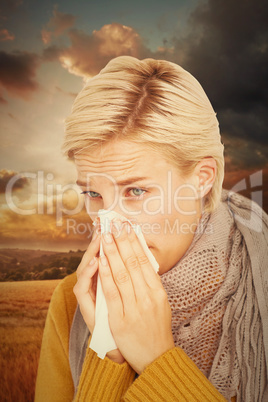 Composite image of close up of woman blowing her nose