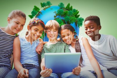 Composite image of happy children using digital tablet at park