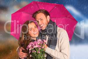 Composite image of cheerful young couple with flowers and umbrel