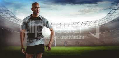 Composite image of sportsman with rugby ball