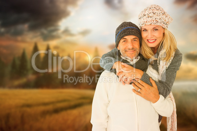 Composite image of portrait of wife embracing husband