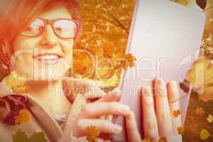 Composite image of portrait of smiling woman in glasses using ta