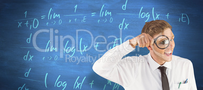 Composite image of geeky businessman looking through magnifying