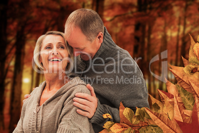 Composite image of happy mature couple in winter clothes