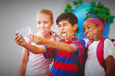 Composite image of school kids taking selfie in school corridor