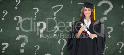 Composite image of full length shot of a graduate holding a degr