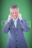 Composite image of businessman with headache