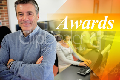 Awards against teacher smiling at top of computer class