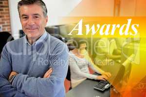 Awards against teacher smiling at top of computer class