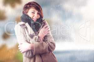 Composite image of portrait of beautiful woman in winter coat