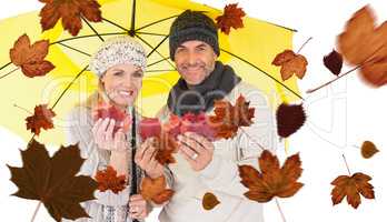 Composite image of portrait of couple holding autumn leaves whil