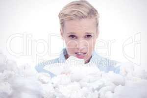 Composite image of blonde sick woman holding lots of tissues