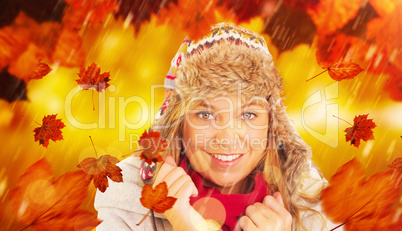 Composite image of happy blonde in winter clothes