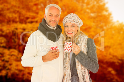 Composite image of portrait of happy couple drinking hot coffee