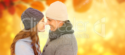 Composite image of couple in warm clothing facing each other