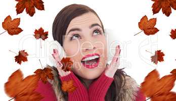 Composite image of surprised brunette in winter clothes