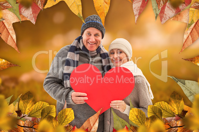 Composite image of happy mature couple in winter clothes holding